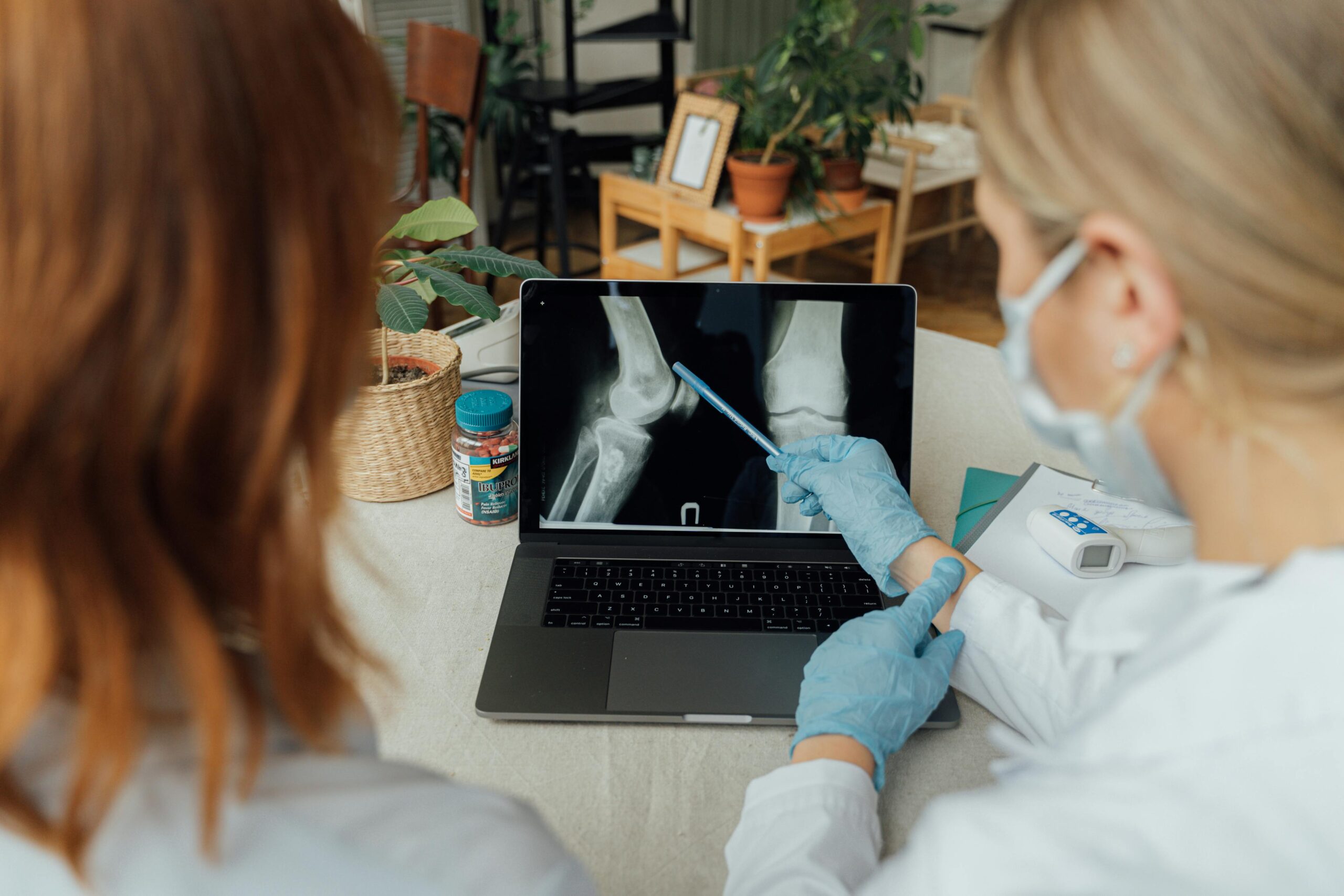 Two doctors examining an X-ray for bone and muscle health assessment. Two doctors examining an X-ray for bone and muscle health assessment.
