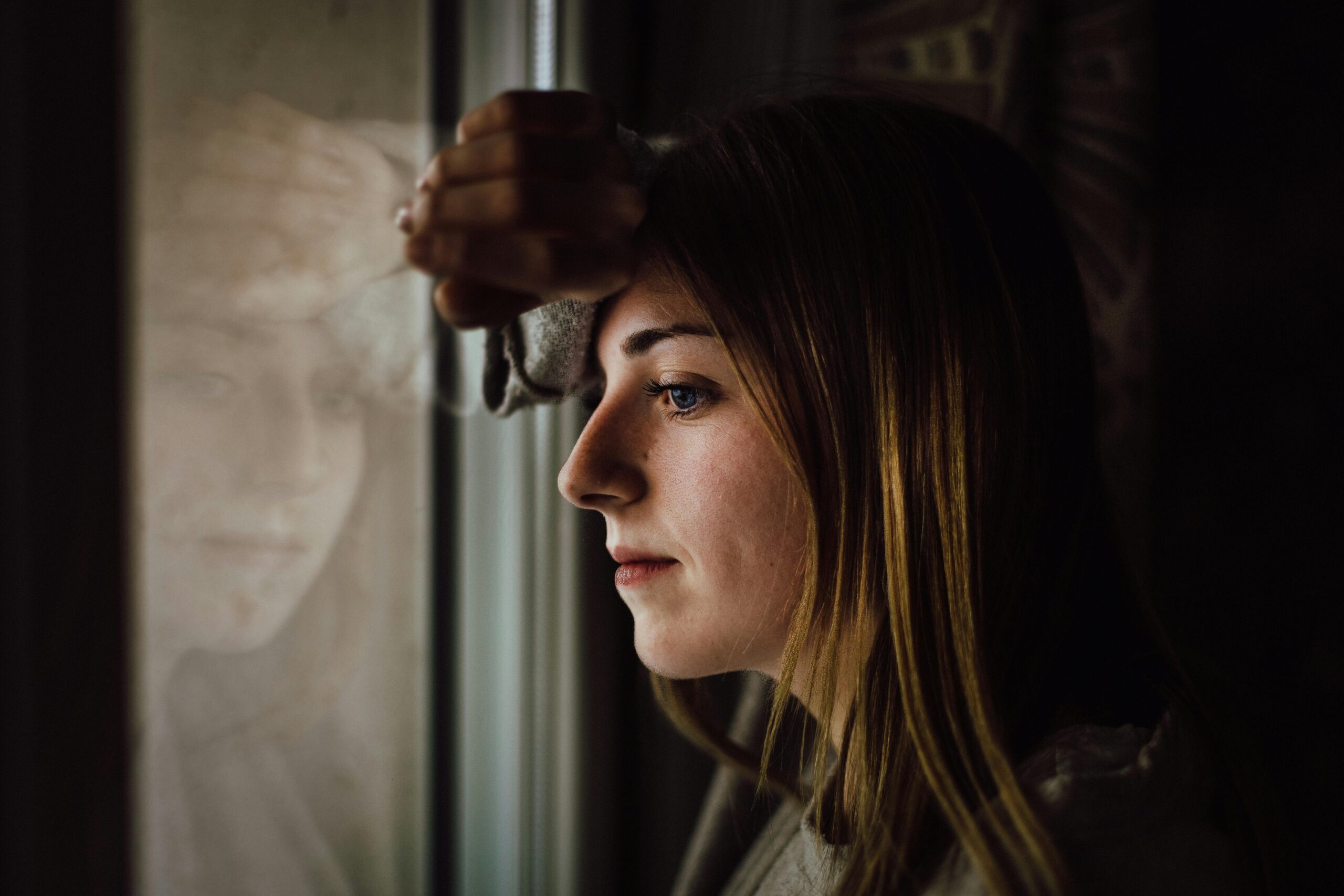 A woman staring out the window A woman staring out the window